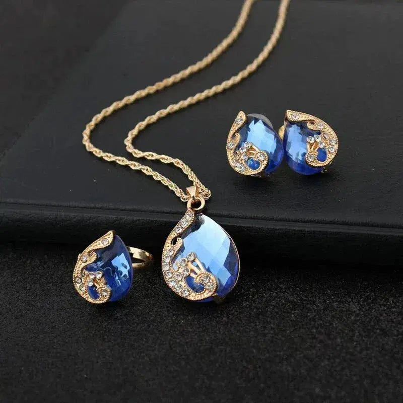 Blue Crystal Necklace + Earring Set in Blue Crystal in Golden